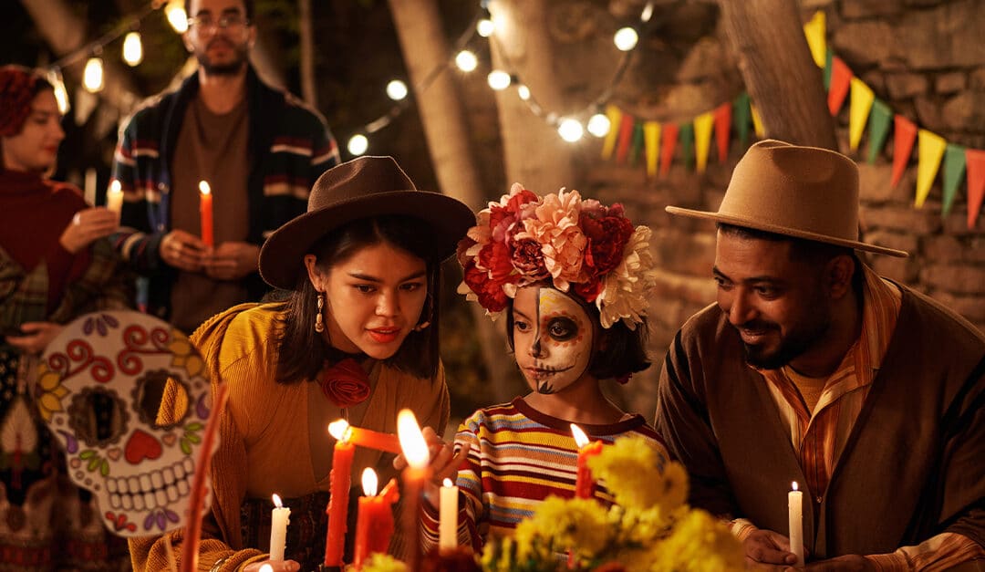 Parents and child celebrating Halloween and Dia de los muertos