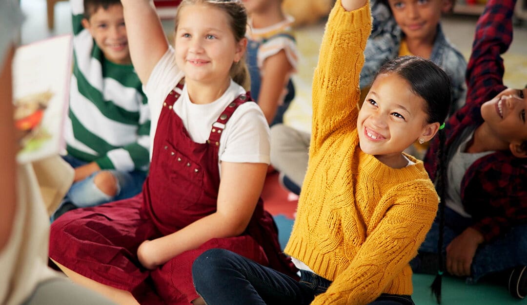 Children, teacher and hands up in classroom for language immersion lessons