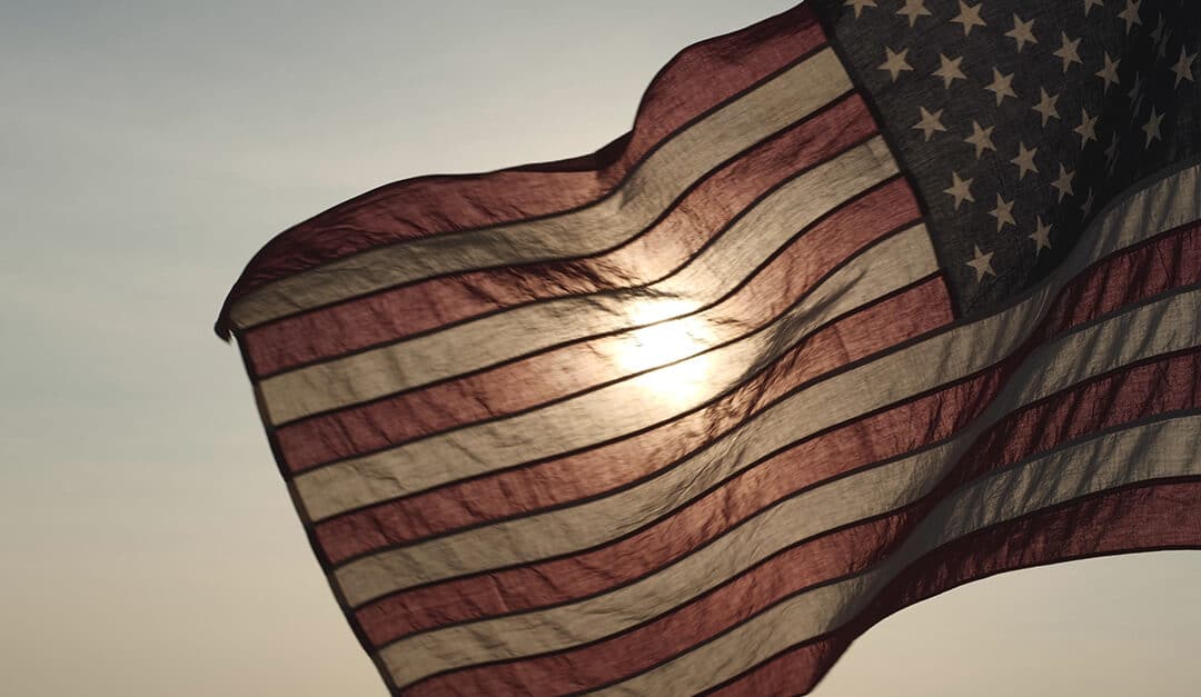 American flag waving in sunset outdoor background for honoring, mourning USA military on Memorial Day