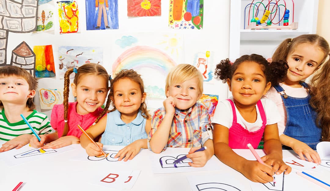 Group of kids, boys and girls in reading class, illustrating the blog topic of Language Learning vs Language Acquisition for Multilingual Children
