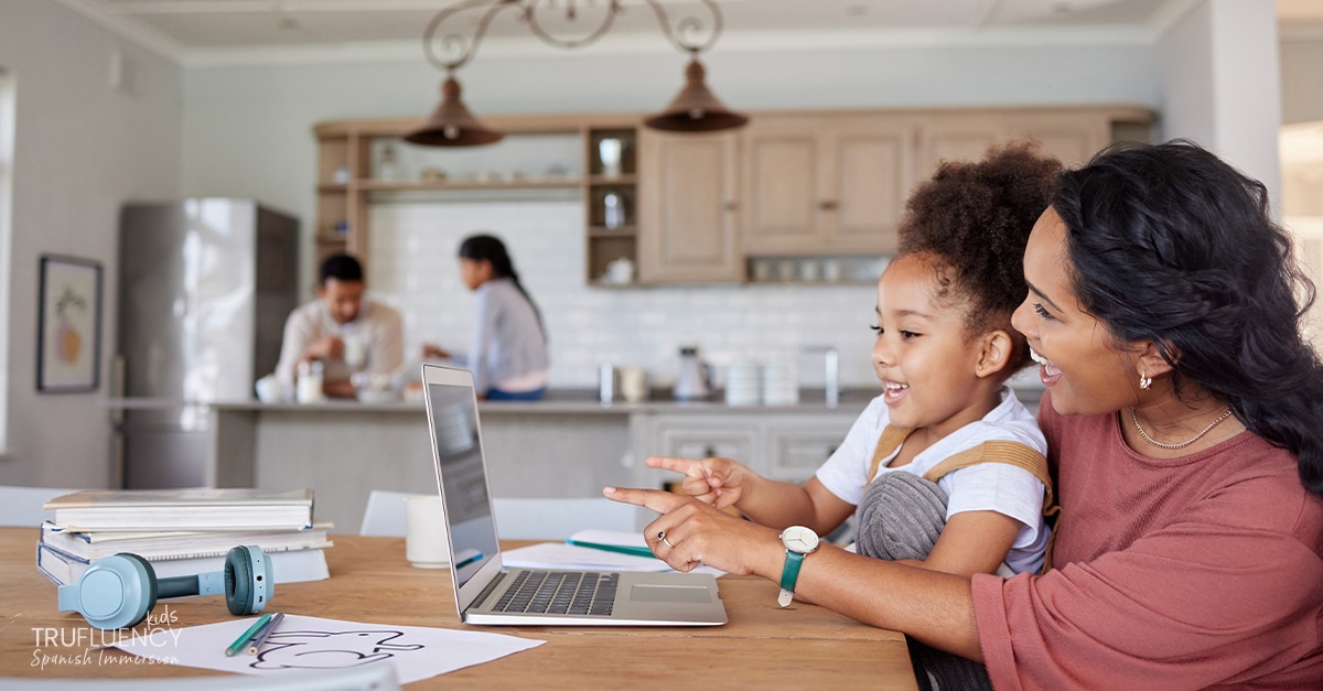 Mother and young daughter homeschool learning Spanish