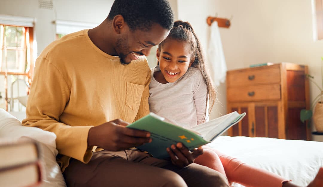 Father reading book with his young daughter